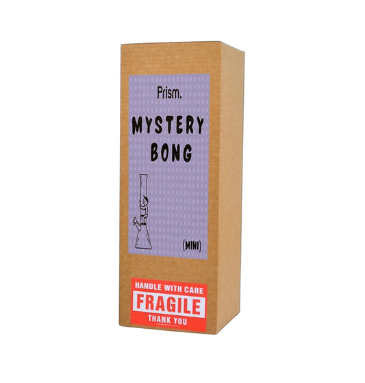 A brown cardboard mystery box with a lavender label reading 'Prism. MYSTERY BONG (MINI)' and a red 'FRAGILE' warning sticker, shown on a plain white background.