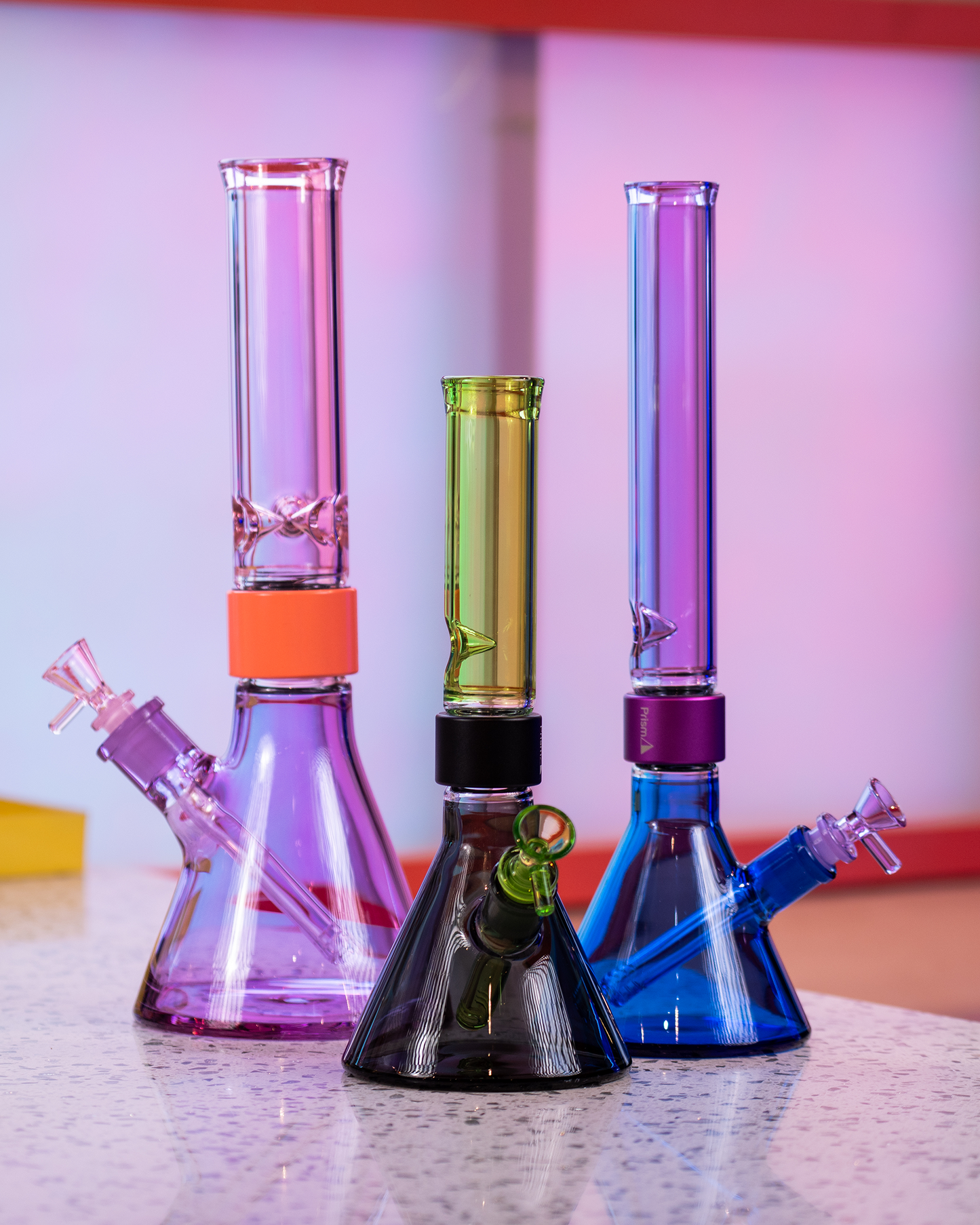 A lineup of three Prism MINI Tall Duo Collection modular beaker bongs showcasing different dual-tone glass colorways: Midnight and Slime green, Sapphire Blue and Grape Jolly Rancher purple, and Grape Jolly Rancher purple and Pink Lemonade. Each modular water pipe demonstrates the customizable glass sections of the Prism system.