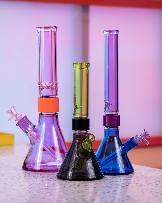 A lineup of three Prism MINI Tall Duo Collection modular beaker bongs showcasing different dual-tone glass colorways: Midnight and Slime green, Sapphire Blue and Grape Jolly Rancher purple, and Grape Jolly Rancher purple and Pink Lemonade. Each modular water pipe demonstrates the customizable glass sections of the Prism system.