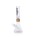 A fully assembled Prism x Sublime official clear glass modular beaker bong. The transparent design offers a clean look, showcasing the gold Halo Connector and the iconic yellow sun logo on the base. The clear glass mouthpiece features the black Sublime gothic logo, emphasizing the "Long Beach, California" roots of the band.
