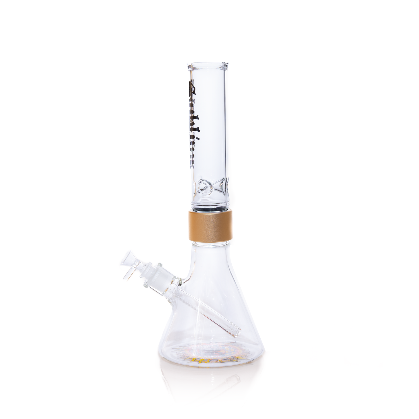 Official Sublime band clear beaker water pipe by Prism, showcasing a 360-degree decal design. The clear mouthpiece features the black gothic "Long Beach California" logo, connected to a clear glass base by a metallic gold anodized ring. This modular setup emphasizes the high-clarity glass and professional finish of this official band collaboration.