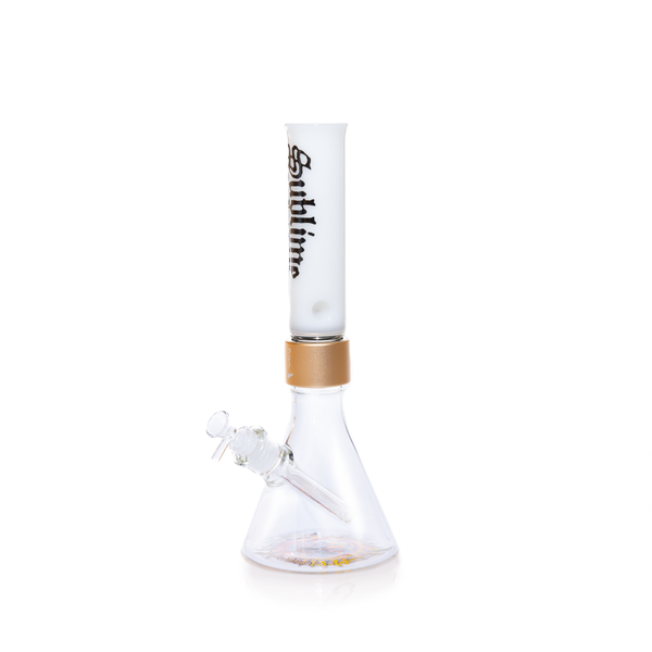 Official Prism x Sublime collaborative modular water pipe featuring a clear glass beaker base with the iconic yellow sun logo by Opie Ortiz on the bottom. This customizable bong includes a metallic gold Halo Connector and a white glass straight tube mouthpiece adorned with the black Sublime gothic logo and Long Beach, California text.