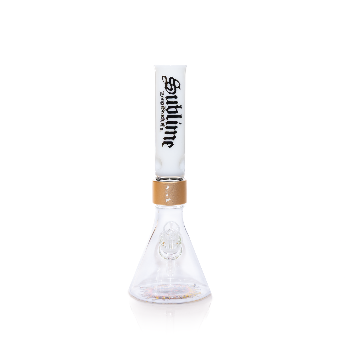 Front-facing view of the Prism x Sublime official white modular beaker bong. This shot highlights the precision 14mm female joint and the crisp application of the Sublime gothic logo on the white glass mouthpiece. The metallic gold Halo Connector creates a premium contrast, while the Opie Ortiz sun decal is clearly visible through the clear glass beaker base.