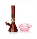 Jane West Ultimate Bundle featuring the amber Prism x Jane West MINI Beaker Bong and matching Twenties Collection Ashtray. The luxury smoking set highlights the diamond-patterned textured glassware and cohesive amber color. The MINI Beaker water pipe is shown with a gold-colored MINI halo connector and 14mm male bowl. Premium glass bundle, designer smoking set, collaborative cannabis glassware, matching amber bong and ashtray, Twenties Collection water pipe.