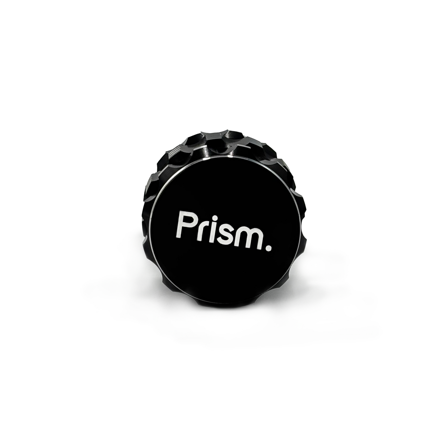 Black 3-Piece aluminum cannabis grinder by Prism Water Pipes. Side view shows branded faceplate and silver, ergonomic grip accents.